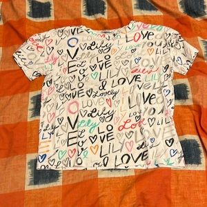 Colorful worded tee with short sleeves.